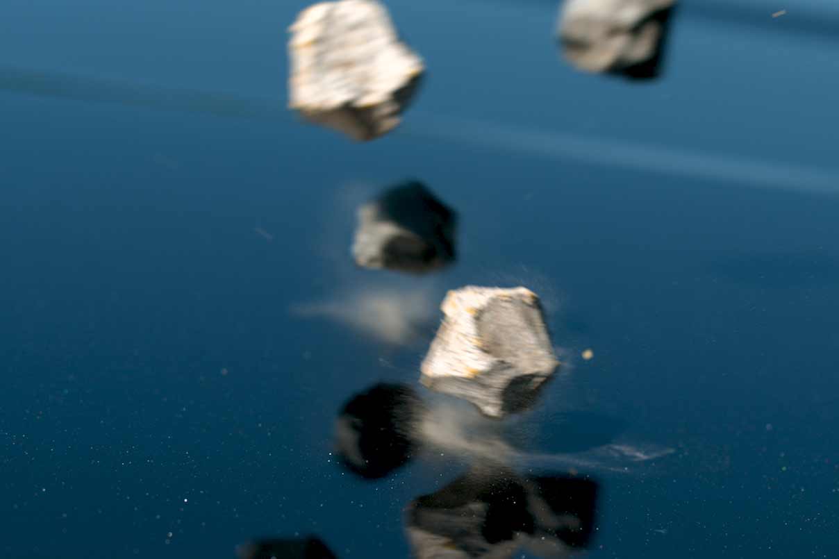 Rocks bounce off a car with PPF protection without causing any demage