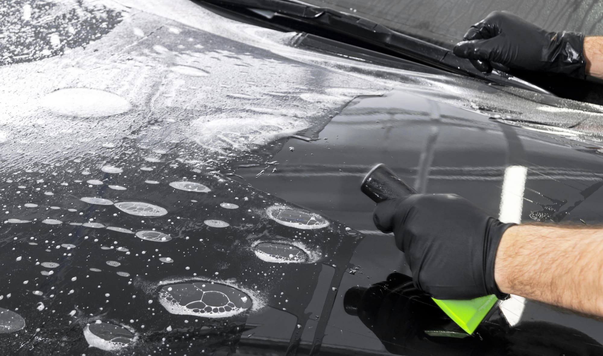 PPF being applied to a black vehicle